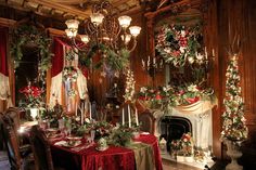 a dining room decorated for christmas with candles and garlands on the fireplace mantel