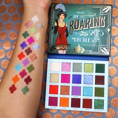 Rude is taking you back in time to the days of rebellious glamour! Join the fun, cut a rug, and jazz up your eyes in these festive shimmers and smooth, pigmented mattes! Get ready to make an unforgettable entrance. It’ll be the talk of the decade. NET WT: 1.06 oz / 30 g How to Use Eyeshadow: Sculpt and define the eyes with matte shades and add dimension with shimmer shades. Can be applied with a brush or with fingers. Ingredients MOONSHINE,CUT A RUG,JAZZ NIGHT,ATTAGIRL,GLITZY,RAZZLE: Mica,Synthe