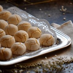 some food that is sitting on a metal tray in front of a cloth and napkin