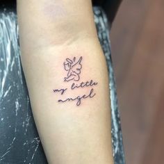 a woman's arm with a small tattoo on it that says my little angel