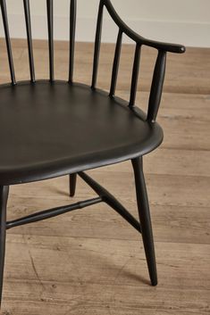 a black chair sitting on top of a wooden floor