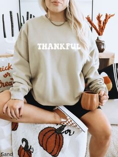 Thankful Sweatshirt, Thanksgiving Crewneck, Thanksgiving Shirts Women, Fall Sweatshirt, Cute Thanksgiving Shirt, Thankful Mom Shirt, Teacher Our shirts are made to order specially for you. Because of this reason we don't accept returns or exchanges. Please check our color and size charts before you place your order. If you have any questions please send us a message to clarify sizing or colors. Ideal for any situation, a unisex heavy blend crewneck sweatshirt is pure comfort. These garments are made from polyester and cotton. This combination helps designs come out looking fresh and beautiful. The collar is ribbed knit, so it retains its shape even after washing. There are no itchy side seams on these sweaters. ✨ 50% cotton, 50% polyester ✨ Medium-heavy fabric 8.0 oz ✨ Loose fit ✨ Sewn-in Pregnancy Sweater, Pumpkin Pregnancy Announcement, Thankful Sweatshirt, Fall Maternity, Sweatshirt Cute, Thanksgiving Shirt, Maternity Sweater, Pregnancy Shirts, Shirts Women