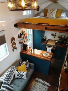 a loft bed is built into the side of a small room with blue and yellow accents