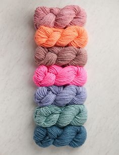 six skeins of yarn in different colors