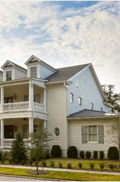 a large white house sitting on the side of a road