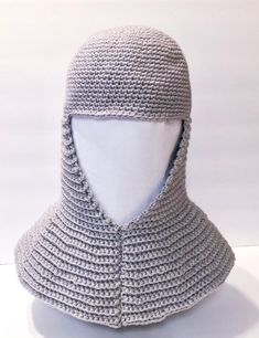 a white mannequin wearing a gray knitted hat