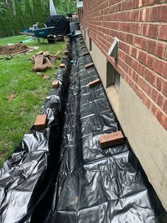 black tarp on the side of a brick building