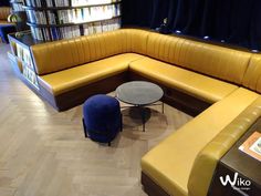 a corner couch and table in a library