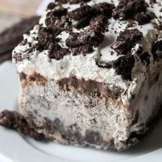 a close up of a piece of cake on a plate with oreo cookies around it