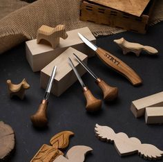 various woodworking tools are arranged on a black surface with burlocks and angel wings