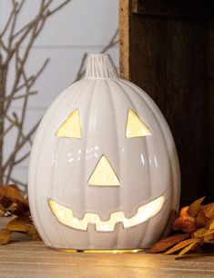 a white pumpkin sitting on top of a wooden table