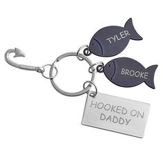 two fish shaped key chains that say,'hooked on daddy'and'tyler brooke hooked on daddy '