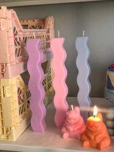 there are candles on the shelf next to each other