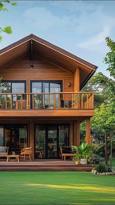 a large wooden house sitting in the middle of a lush green field with lots of trees