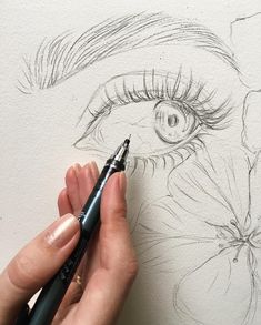 someone is drawing an eye with a pencil