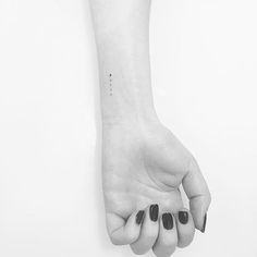 a black and white photo of a woman's hand with the word love on it