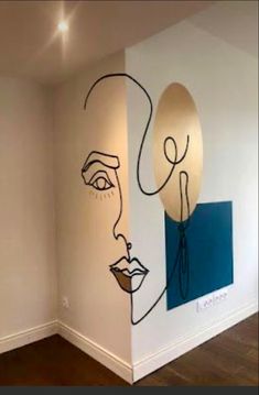 a room with two paintings on the wall