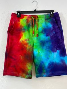 Ice tie dye small sized unisex shorts. These shorts are pull on, have a elastic waist and a shoestring drawcord. Has 2 side pockets and one in the rear! No fly opening, just pull it off when needed! These are fleece lined shorts, sweatshirt material. The side pockets are jersey lined, tapered knee opening. 80% cotton and 20% poly, easy machine wash and dry with dark colors and machine dry. Measurements are garment laid out flat  15 inches from waist edge to edge 18 1/2 inches from top of waist to bottom hem down front  9 inch inseam Multicolor Relaxed Fit Bottoms With Drawstring, Casual Multicolor Drawstring Bottoms, Casual Tie-dye Shorts With Relaxed Fit, Casual Tie Dye Shorts With Relaxed Fit, Casual Rainbow Cotton Bottoms, Casual Tie Dye Relaxed Fit Shorts, Casual Multicolor Bermuda Bottoms, Casual Relaxed Fit Tie Dye Shorts, Casual Tie Dye Shorts With Elastic Waistband