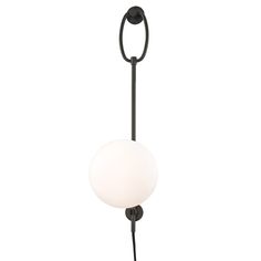 a light that is on the side of a white wall mounted lamp with a black metal pole