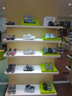 there are many pairs of shoes on the shelves