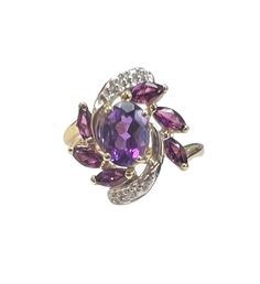 An oval Amethyst centers this pretty ring. Three marquise-shaped rhodolite garnets are angled on each side and tiny diamond accents swirl around the top and bottom of the ring.  10 karat yellow gold Diamonds are set in white gold Size 8 - can be sized Amethyst is the birthstone for February Oval Multi-stone Amethyst Gemstones, Purple Oval Ruby Ring, Fine Jewelry, Fine Jewelry Oval Multi-stone Amethyst Ring, Formal Oval Amethyst Multi-stone Ring, Oval Multi-stone Amethyst Ring For Formal Occasions, Formal Multi-stone Oval Amethyst Ring, Formal Oval Amethyst Ring With Multiple Stones, Bridal Jewelry Vintage, Pretty Ring