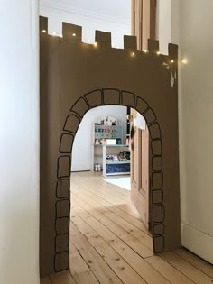 an arch made out of cardboard and string lights