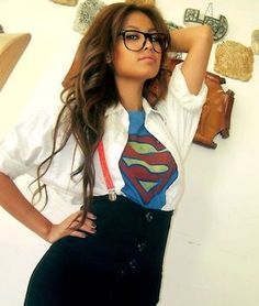 a woman wearing glasses and a superman tie