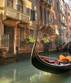 a gondola floating on the water in front of buildings