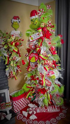 a christmas tree decorated with red, green and white ribbons in the shape of dr seuss