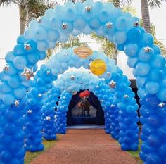 an archway decorated with blue balloons and stars