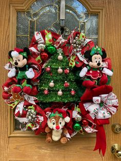 a christmas wreath with mickey and minnie mouses on it