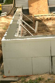 a cement block sitting next to a building under construction