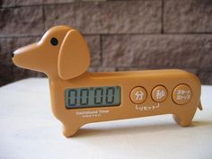 an orange dog clock sitting on top of a table