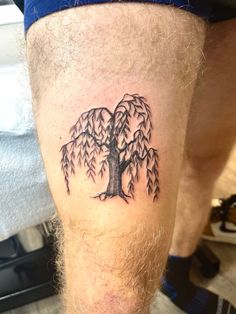 a man with a tree tattoo on his leg