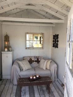 a living room with white walls and wood floors