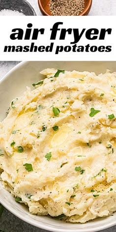 a white bowl filled with mashed potatoes and garnished with parsley