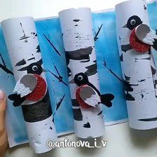 the paper roll is decorated to look like a bird on a birch tree with red glitter eyes