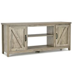 a large wooden tv stand with sliding doors on the front and side panels in whitewash