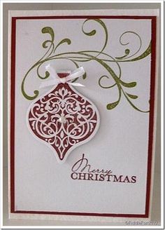 a christmas ornament hanging from the side of a white card with red trim