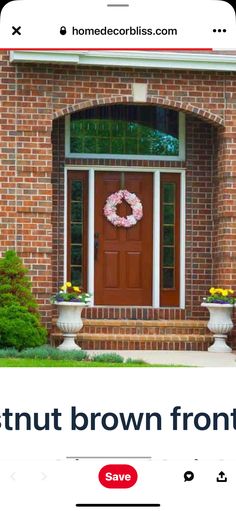 a red brick house with a wreath on the front door that says, chestnutnut brown front door