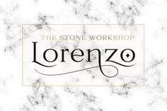 the stone workshop logo on top of a white marble background with black and gold lettering