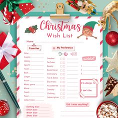 a christmas wish list on a clipboard surrounded by holiday decorations and other items, including candy