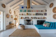 a living room filled with furniture and a fire place under a roof covered in wicker