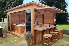 a wooden hot tub sitting next to a picnic table