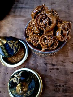 two bowls filled with food sitting on top of a wooden table next to each other