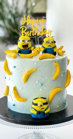 a birthday cake with three minion characters on it