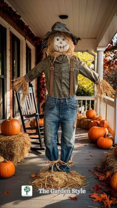 scarecrow standing on porch with hay bales and pumpkins