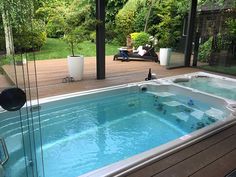 a large hot tub sitting on top of a wooden deck