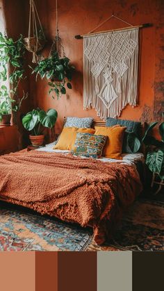 a bedroom with orange walls and lots of plants