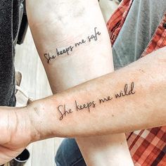 two people with tattoos on their arms that say she keeps me safe, she keeps me wild